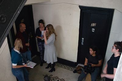 A film crew meeting in a stairwell